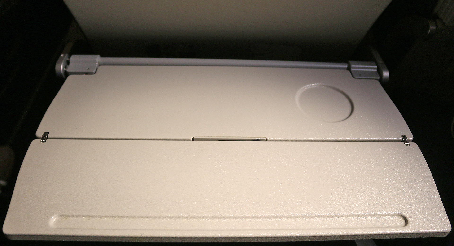 a white plastic object with a round lid