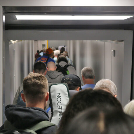 a group of people walking down a hallway