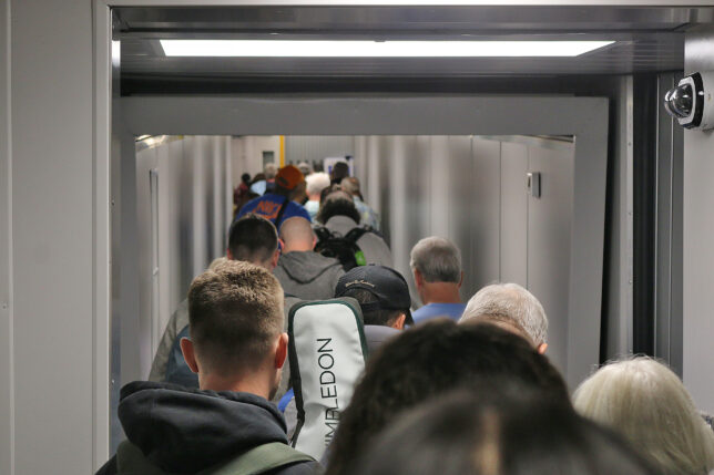 a group of people walking down a hallway
