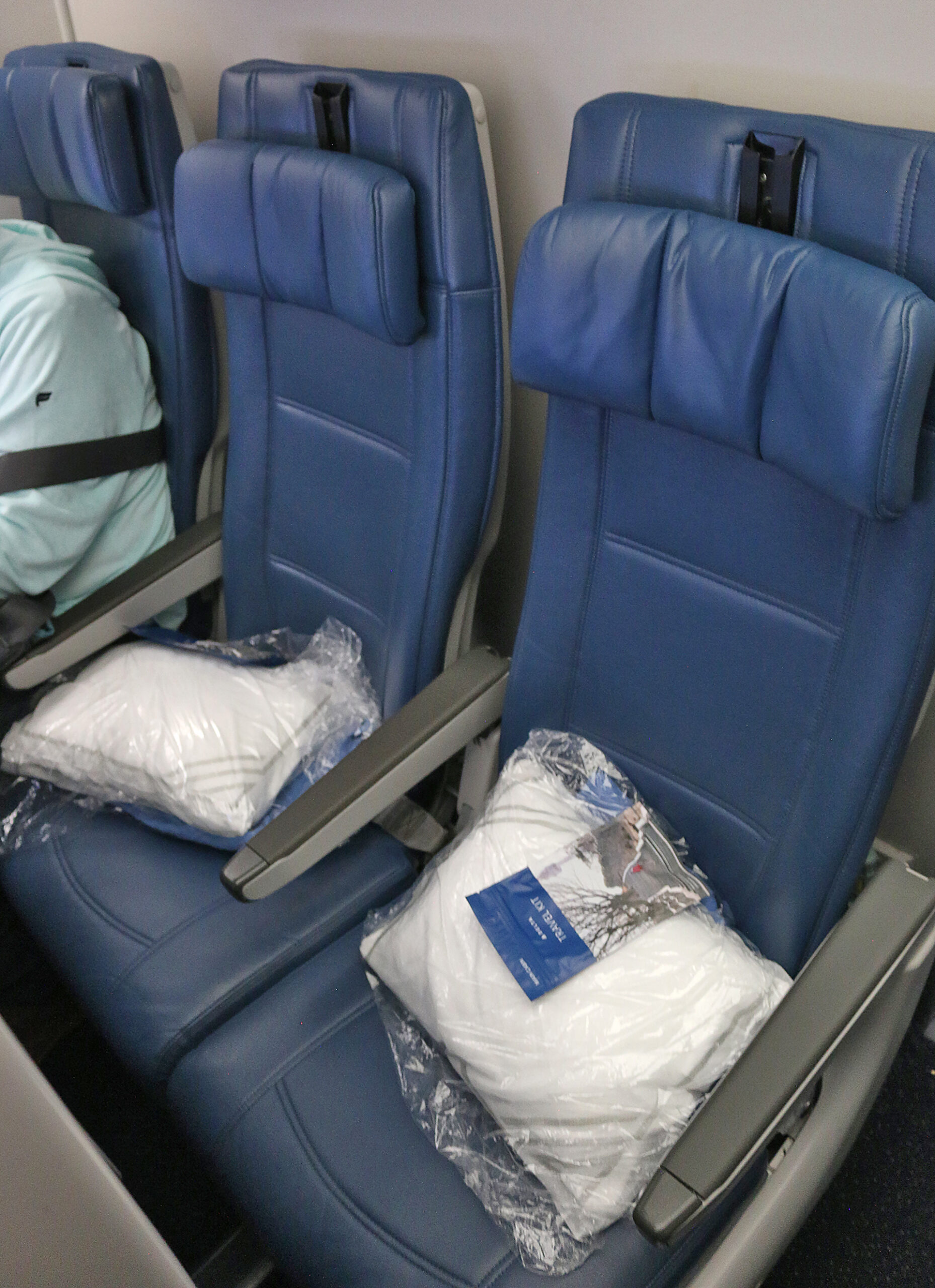 a blue seats with white pillows