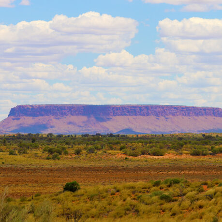 a landscape with a large hill in the distance