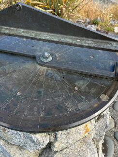 a sundial on a rock