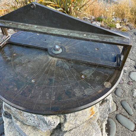 a sundial on a rock