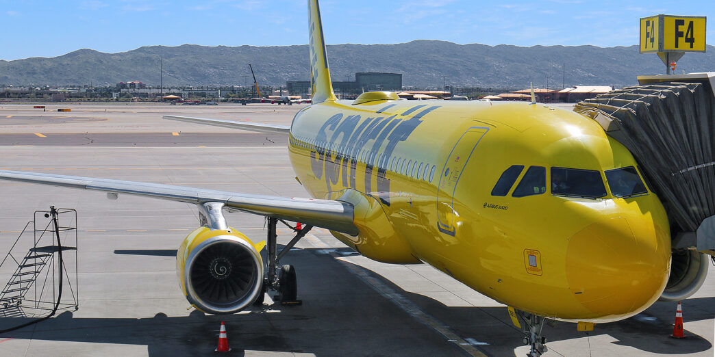 a yellow airplane on a runway