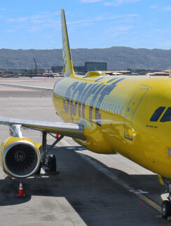 a yellow airplane on a runway