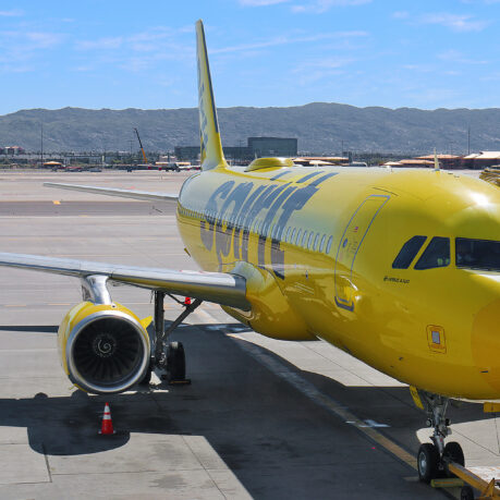 a yellow airplane on a runway