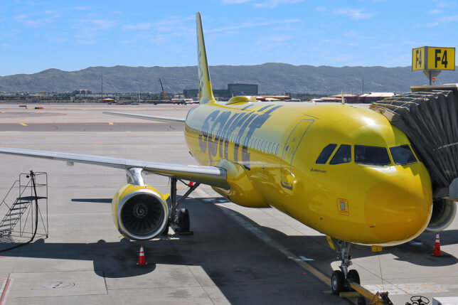 a yellow airplane on a runway