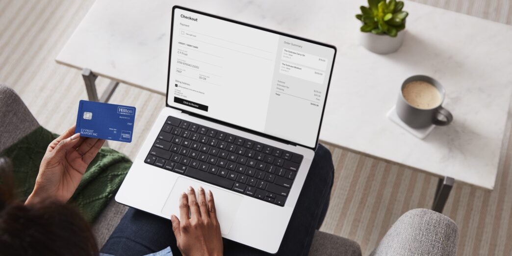 a person sitting on a couch using a laptop