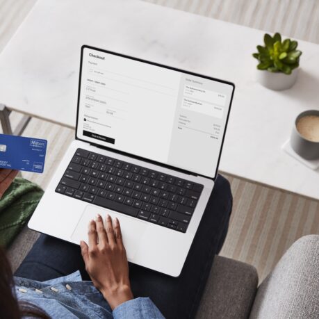 a person sitting on a couch using a laptop