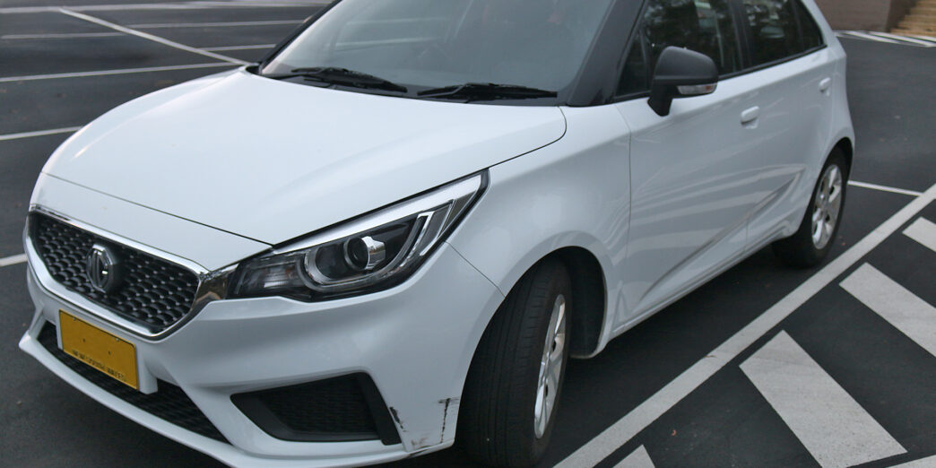 a white car parked in a parking lot
