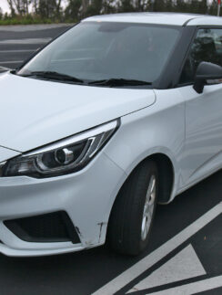 a white car parked in a parking lot