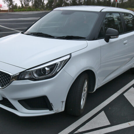 a white car parked in a parking lot