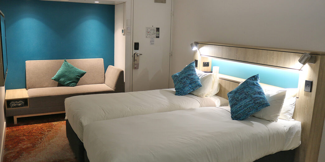 a room with two beds and a door