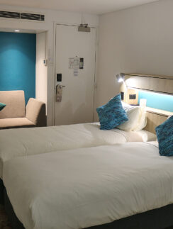 a room with two beds and a door