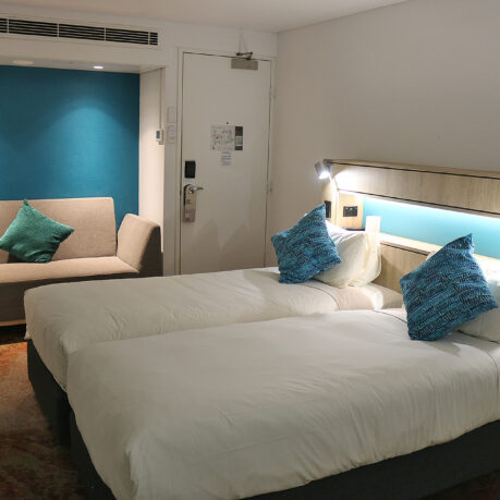 a room with two beds and a door