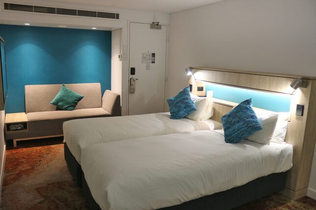 a room with two beds and a door