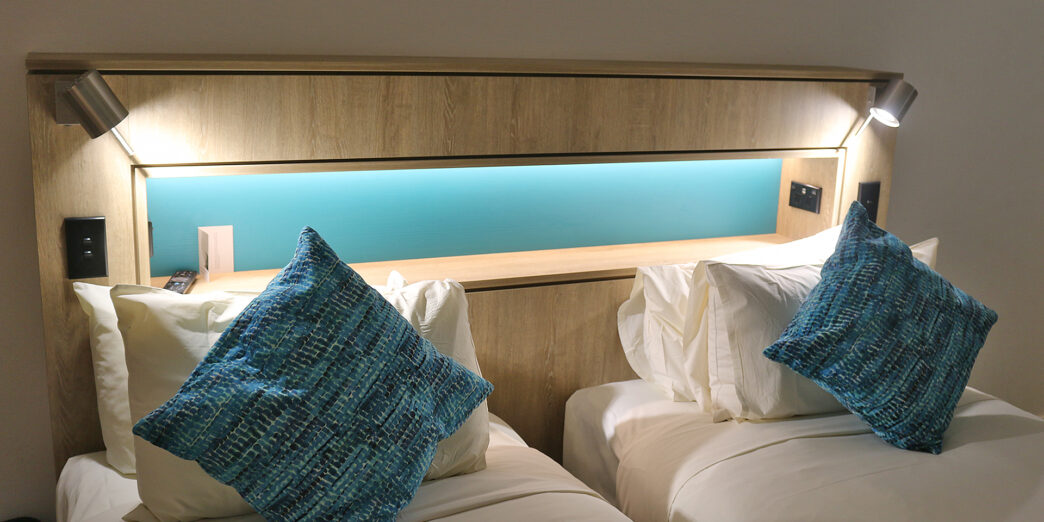 two beds with pillows on each other