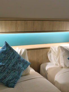 two beds with pillows on each other