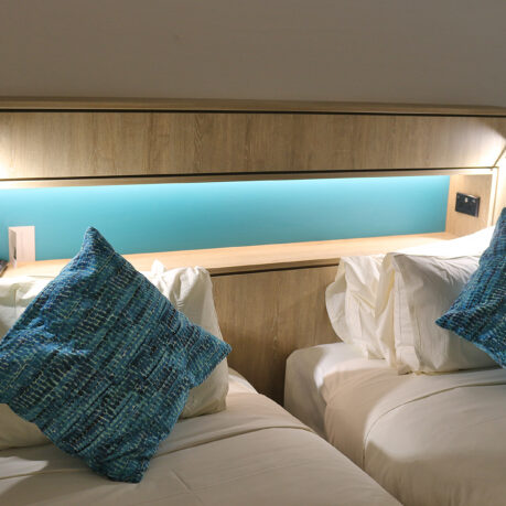 two beds with pillows on each other