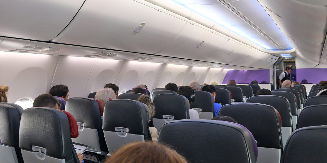 a group of people sitting in an airplane