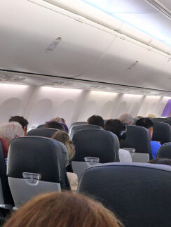 a group of people sitting in an airplane