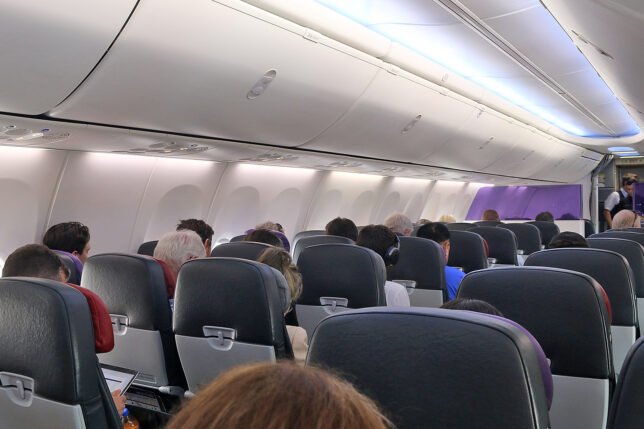 a group of people sitting in an airplane