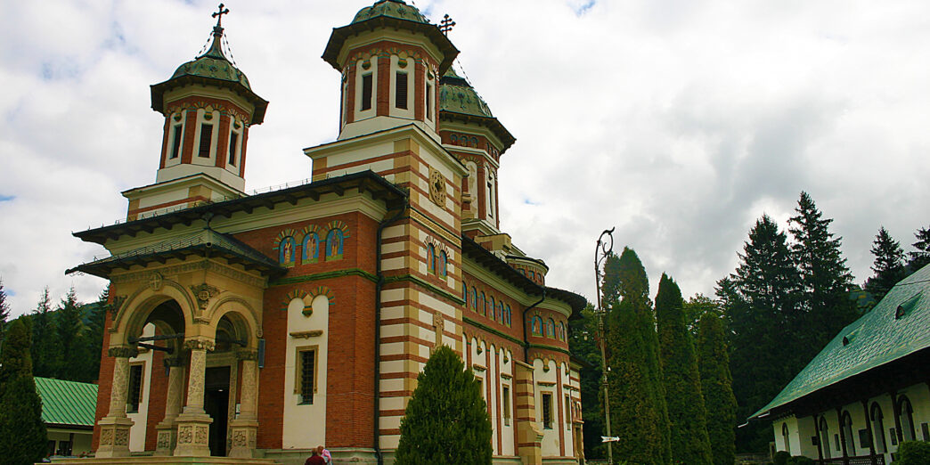 a building with a couple of people walking in front of it