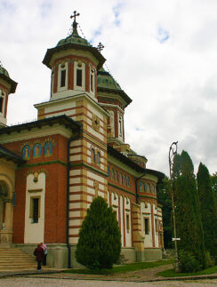 a building with a couple of people walking in front of it