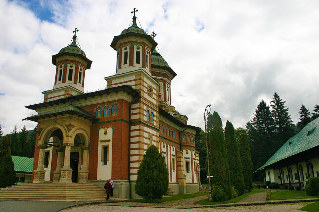 a building with a couple of people walking in front of it