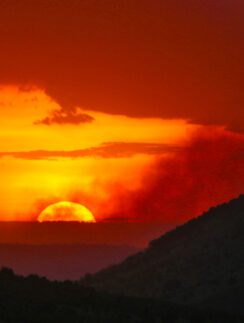 a sunset over a mountain