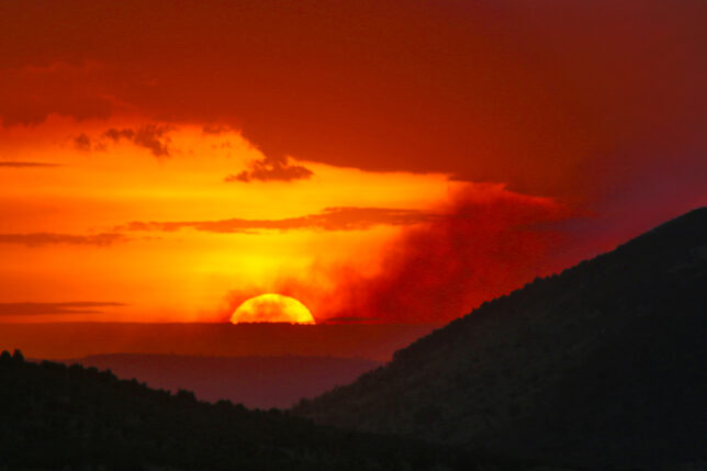 a sunset over a mountain