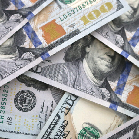 a pile of money with a face on it