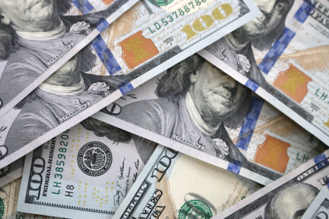 a pile of money with a face on it