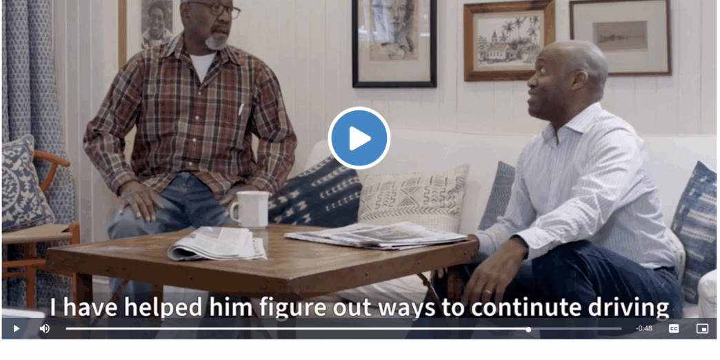 two men sitting on a couch