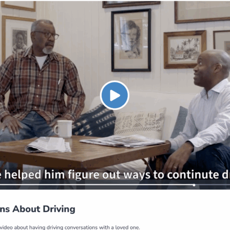 two men sitting on a couch