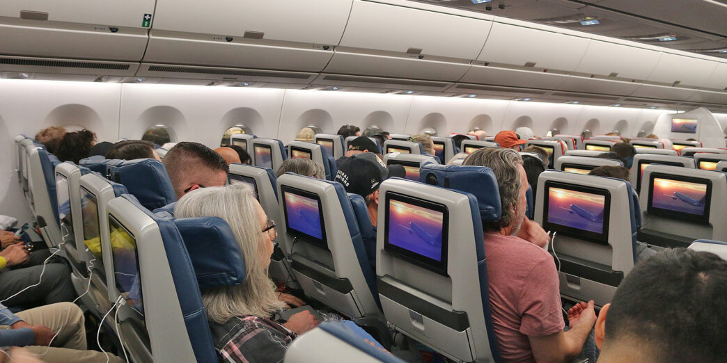 a group of people sitting in an airplane