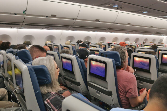 a group of people sitting in an airplane