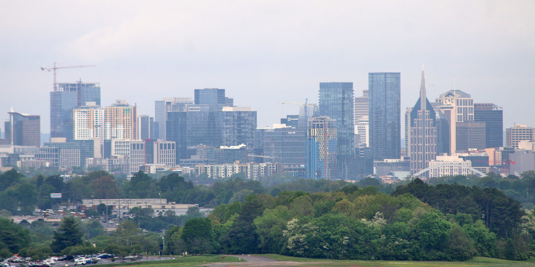 a city skyline with trees in the background