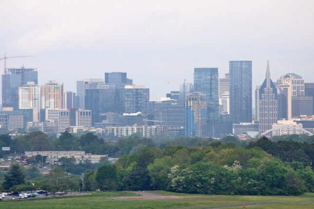 a city skyline with trees in the background