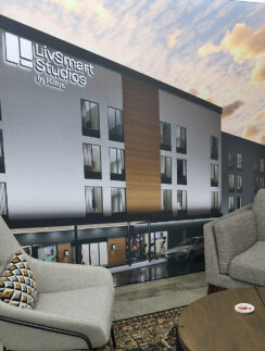 a room with a large wall with a picture of a building