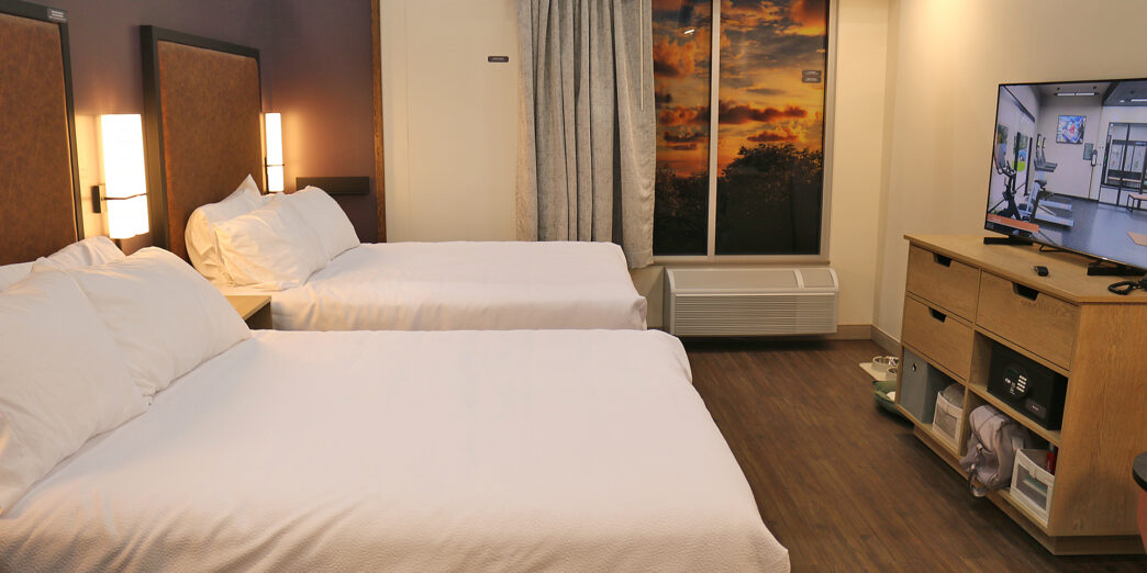 a room with two beds and a window