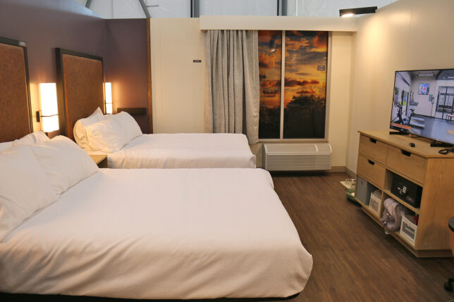 a room with two beds and a window