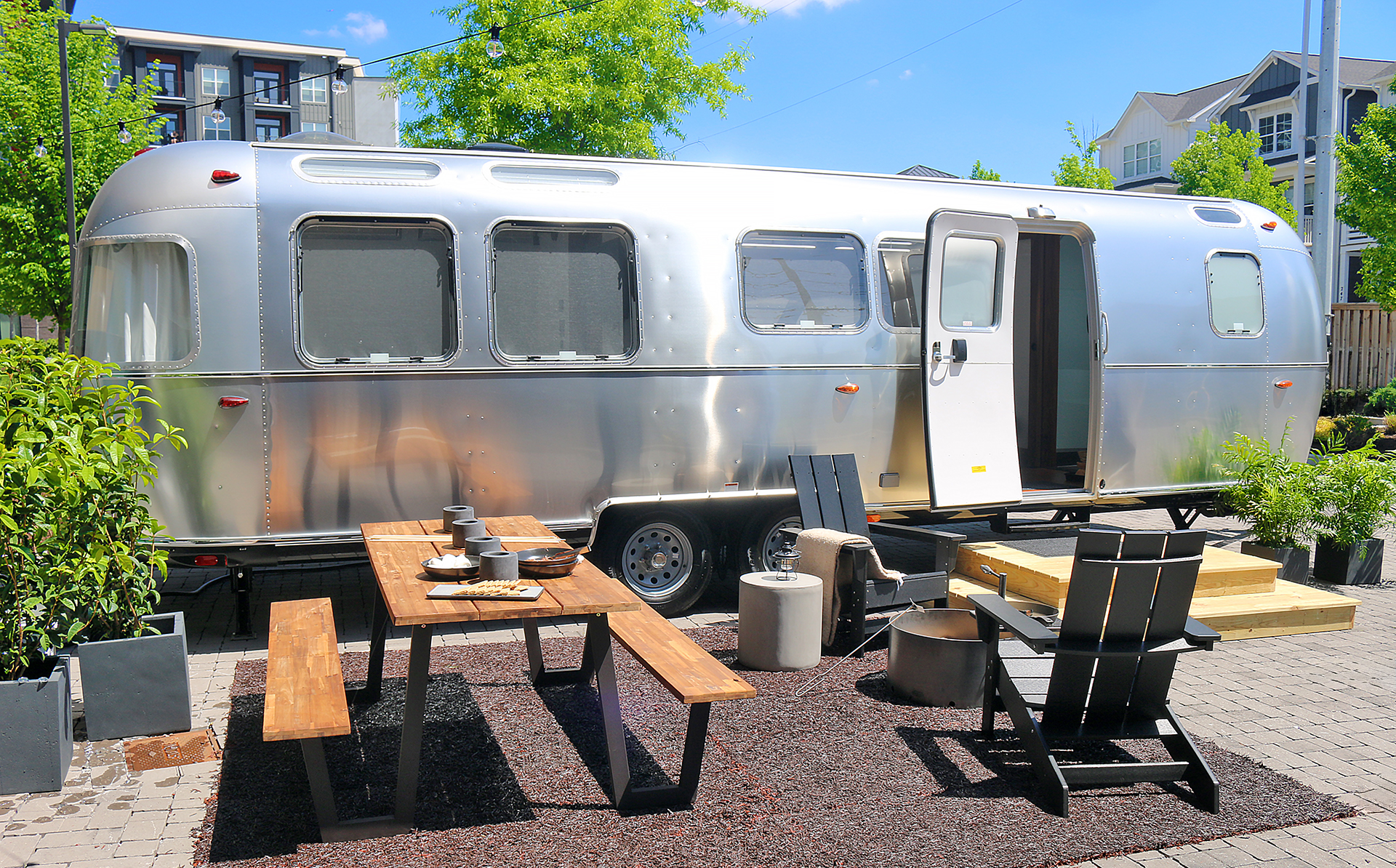 a silver trailer with chairs and tables