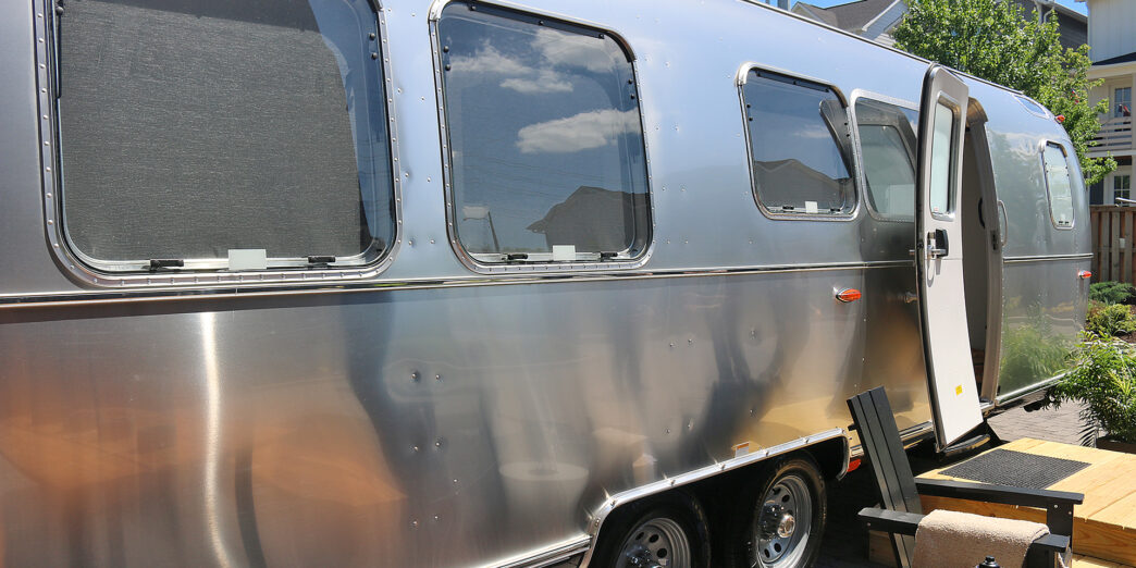 a silver trailer with a door open