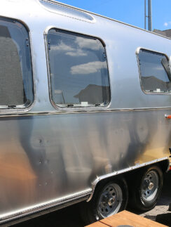 a silver trailer with a door open