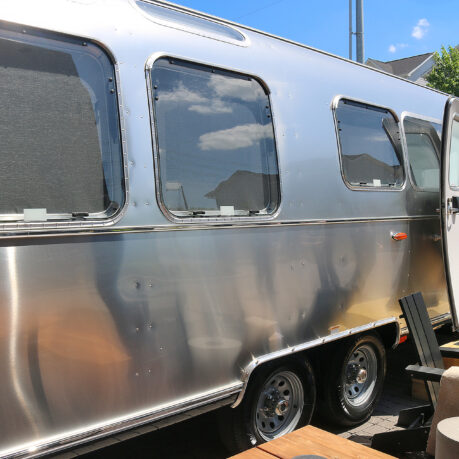 a silver trailer with a door open