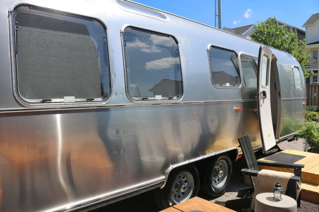 a silver trailer with a door open