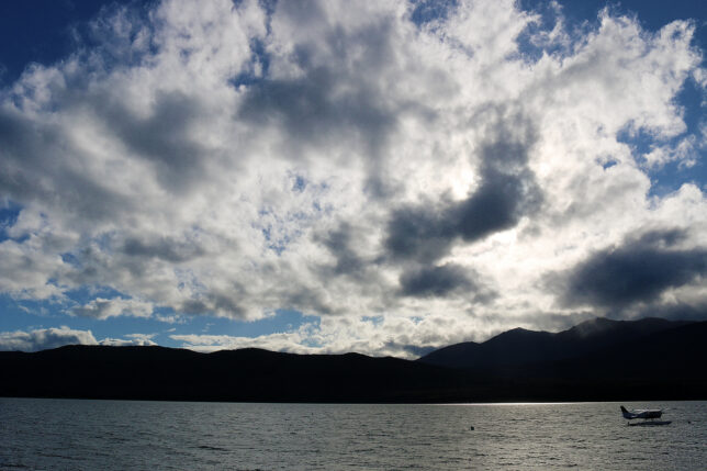 a body of water with mountains in the background