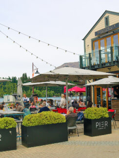 a group of people sitting outside a restaurant
