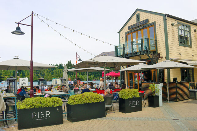 a group of people sitting outside a restaurant